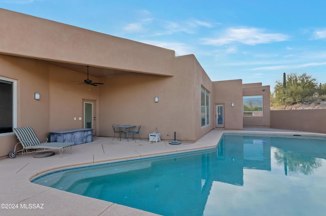 view of swimming pool featuring ceiling fan and a patio area