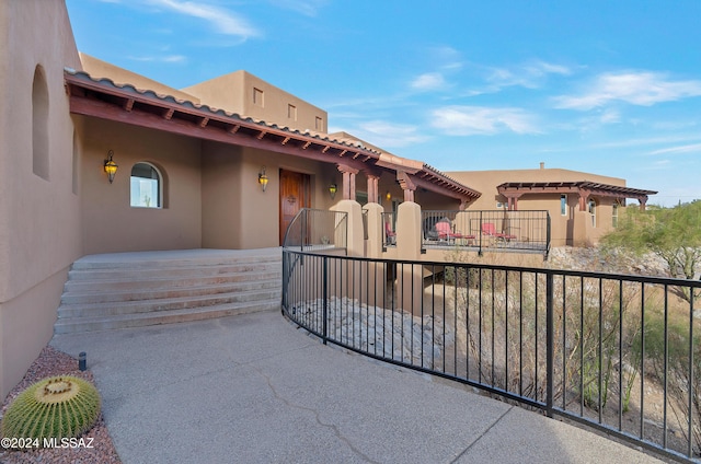 exterior space featuring stucco siding and a patio