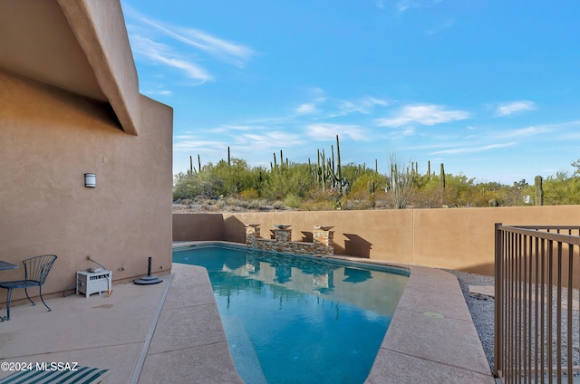 view of swimming pool featuring a fenced in pool, a patio, and fence