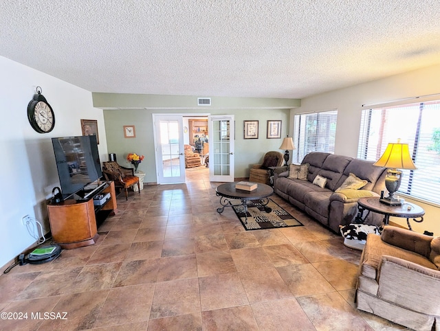 living room with french doors and a textured ceiling