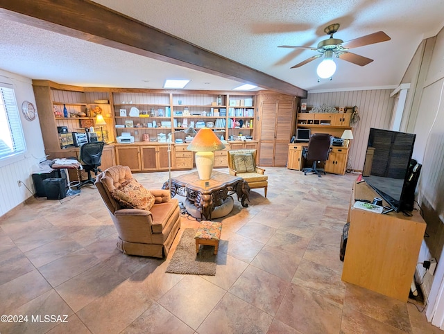 interior space with beam ceiling, ceiling fan, built in features, a textured ceiling, and light tile patterned floors