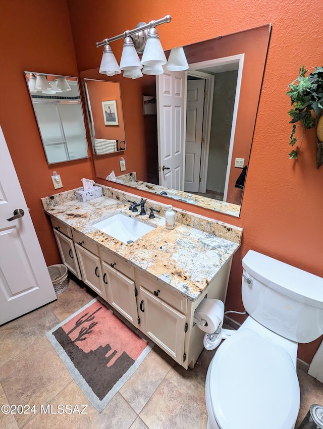 bathroom featuring tile patterned floors, vanity, and toilet