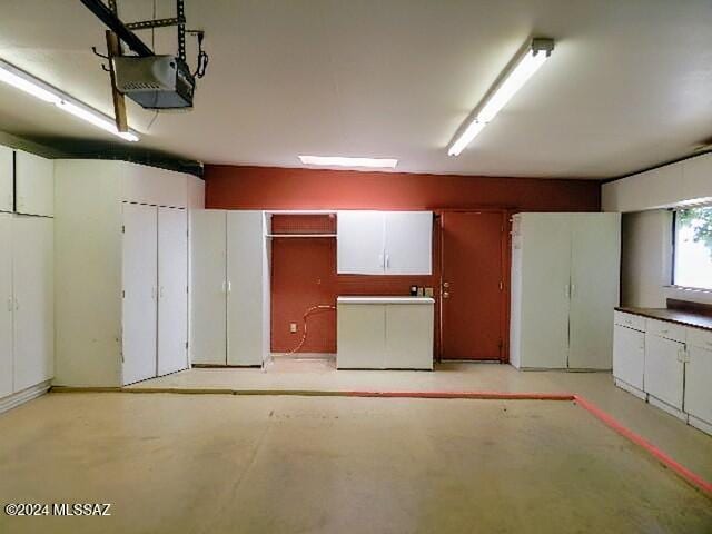 garage featuring refrigerator and a garage door opener