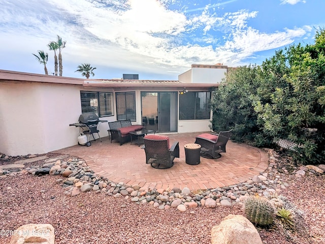 back of house with a sunroom and a patio