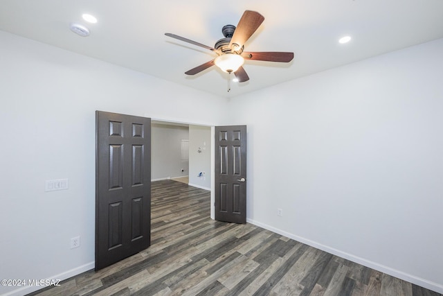 spare room featuring ceiling fan and dark hardwood / wood-style flooring