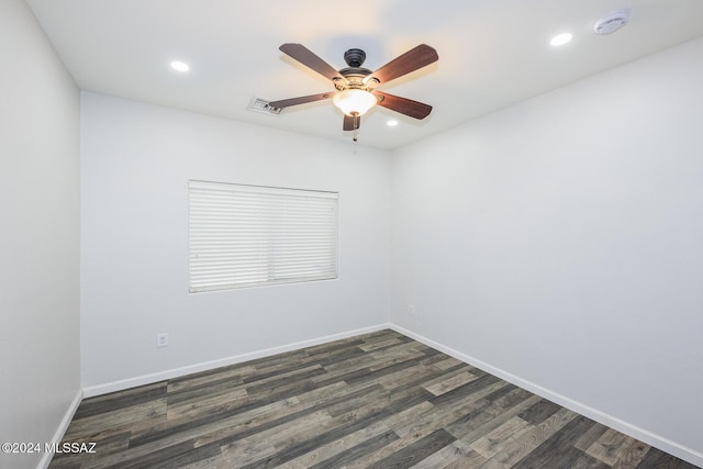 spare room with dark wood-type flooring