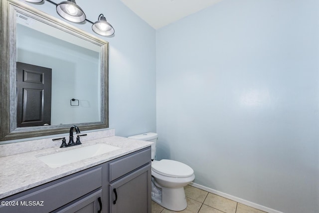 bathroom with tile patterned floors, vanity, and toilet