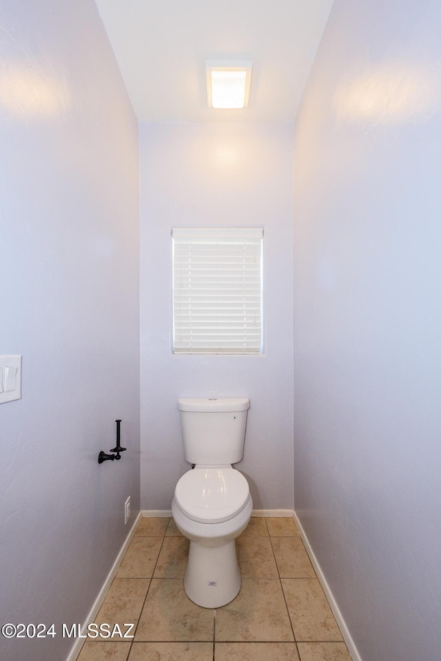 bathroom featuring tile patterned flooring and toilet