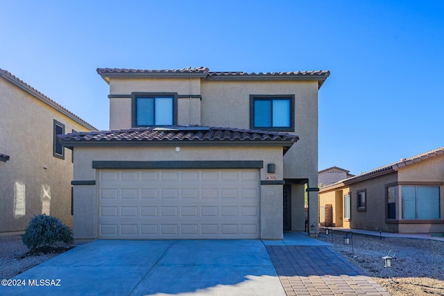 mediterranean / spanish-style home featuring a garage