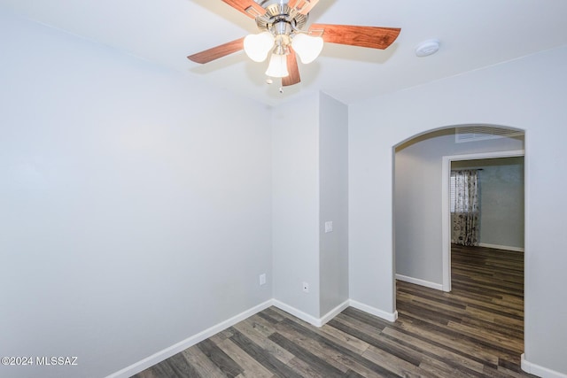 empty room featuring ceiling fan and dark hardwood / wood-style flooring