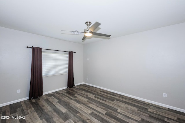 unfurnished room with dark wood-type flooring