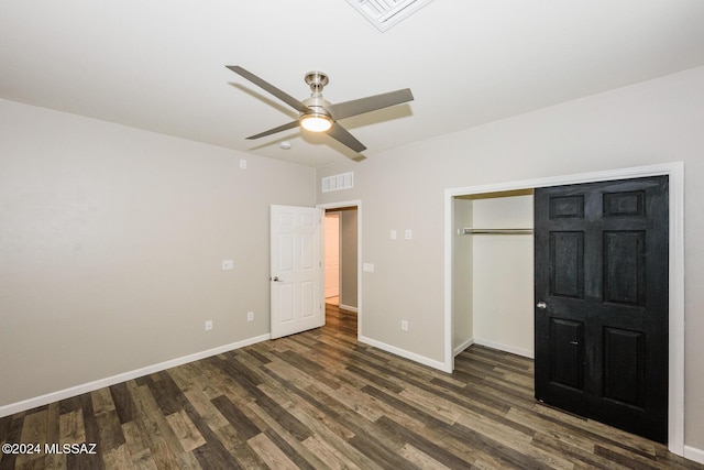 unfurnished bedroom with a closet, dark hardwood / wood-style floors, and ceiling fan