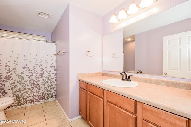 bathroom with toilet, vanity, tile patterned floors, and a shower with shower curtain