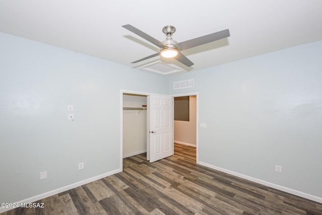 unfurnished bedroom featuring ceiling fan, a closet, and dark wood-type flooring