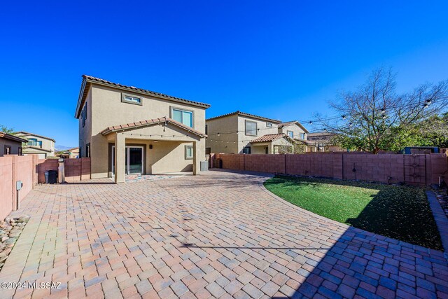 back of house with a patio