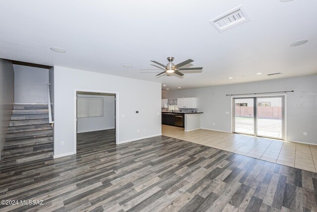 unfurnished living room with tile patterned floors and ceiling fan