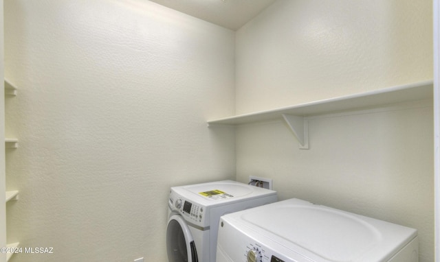 clothes washing area with washing machine and dryer