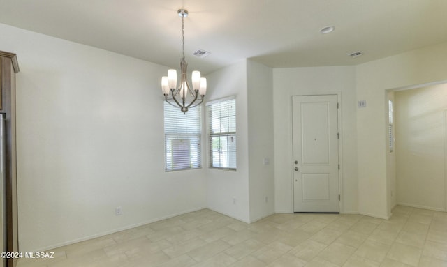 empty room featuring a chandelier