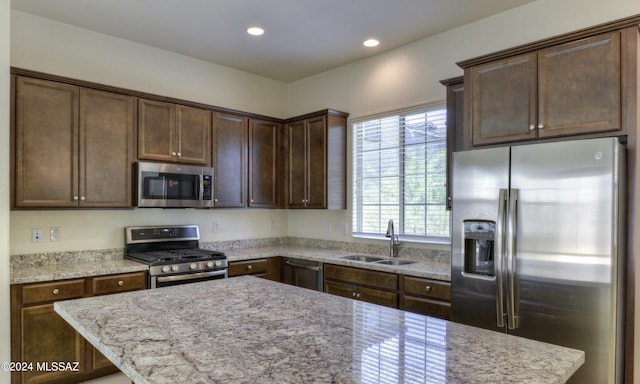 kitchen featuring dark brown cabinets, stainless steel appliances, and sink