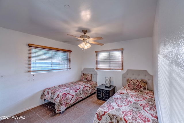 tiled bedroom featuring ceiling fan