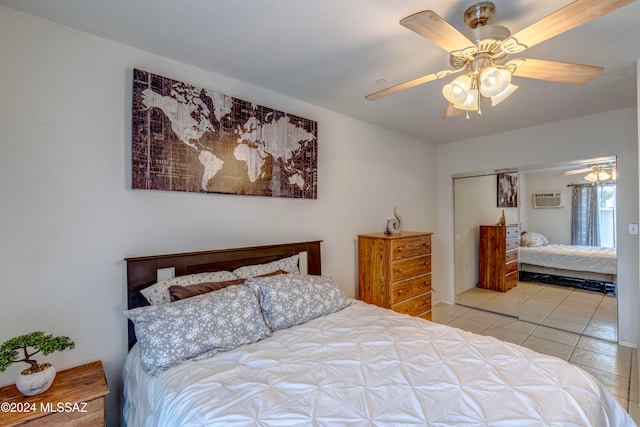 tiled bedroom with ceiling fan, a wall unit AC, and a closet