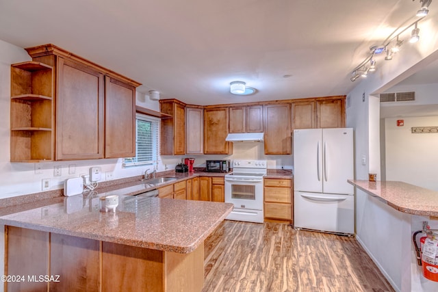 kitchen featuring kitchen peninsula, white appliances, light hardwood / wood-style floors, and sink