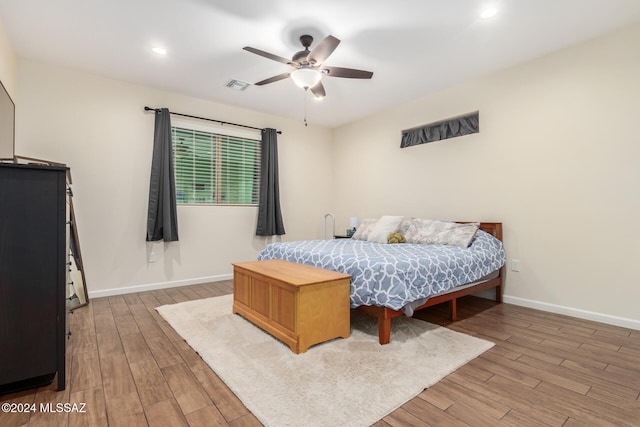 bedroom with hardwood / wood-style flooring and ceiling fan