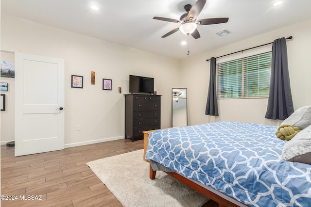 bedroom featuring ceiling fan and light hardwood / wood-style flooring