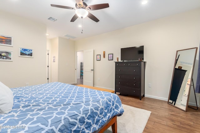 bedroom with light hardwood / wood-style flooring and ceiling fan