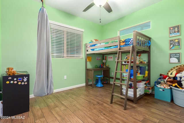 bedroom with ceiling fan and wood-type flooring