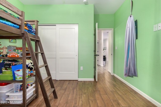 bedroom featuring light wood-type flooring and a closet