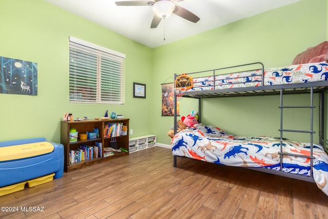 bedroom with ceiling fan and hardwood / wood-style flooring