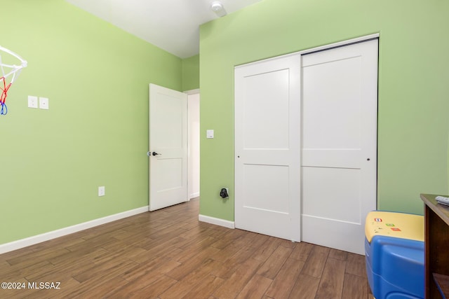 unfurnished bedroom with a closet and hardwood / wood-style flooring