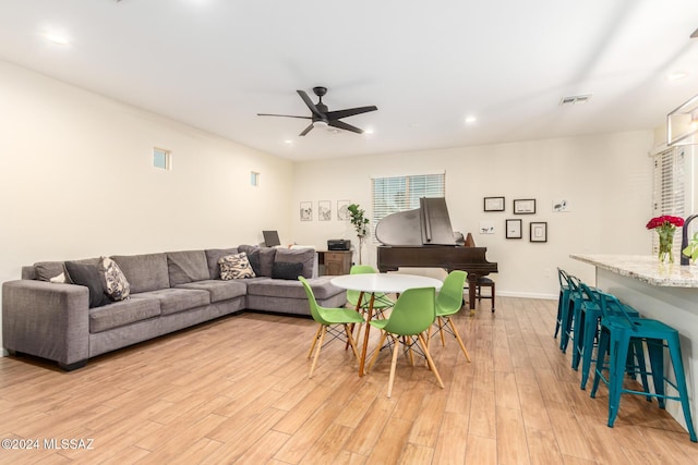 living room featuring ceiling fan and light hardwood / wood-style floors