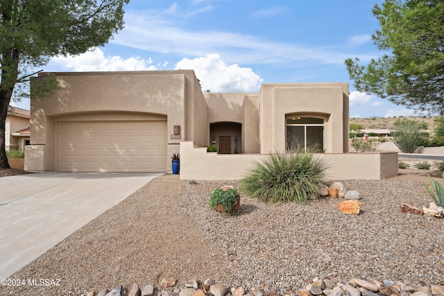 pueblo-style house with a garage