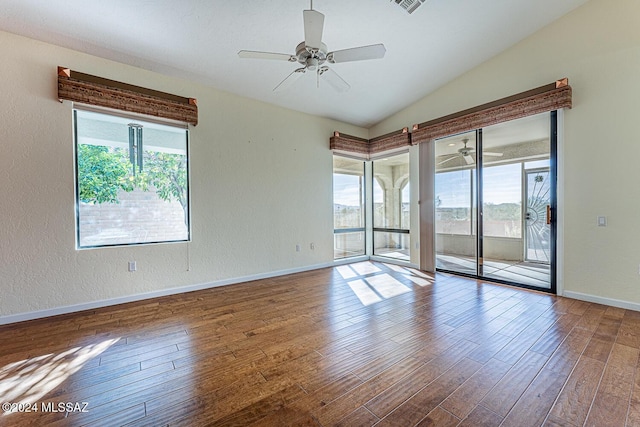 unfurnished room featuring wood-type flooring, a healthy amount of sunlight, and ceiling fan