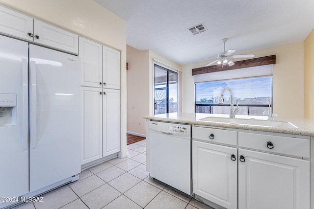 kitchen with white cabinetry, white appliances, light tile patterned flooring, and sink