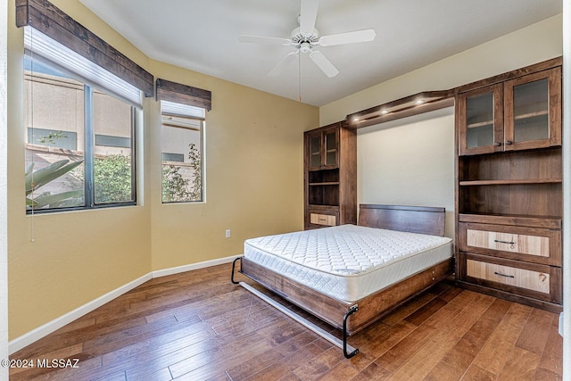 bedroom with dark wood-type flooring and ceiling fan