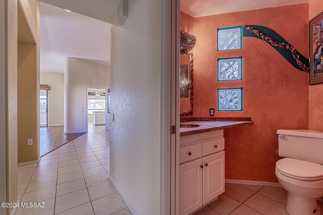 bathroom featuring tile patterned flooring, vanity, and toilet