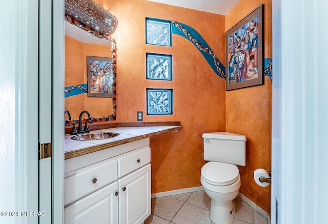 bathroom with vanity, toilet, and tile patterned flooring