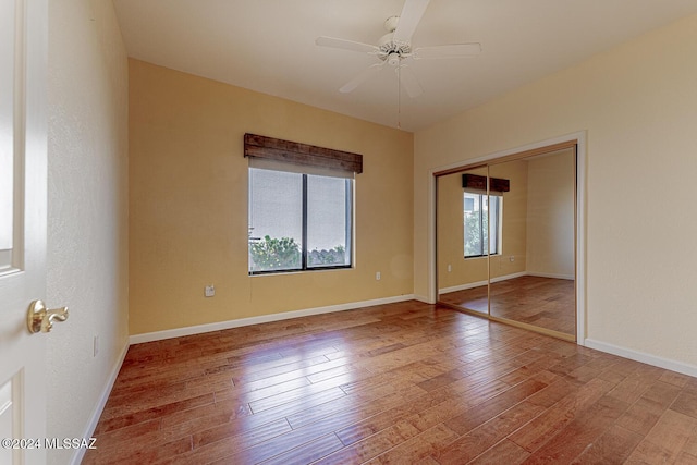 spare room with ceiling fan and wood-type flooring