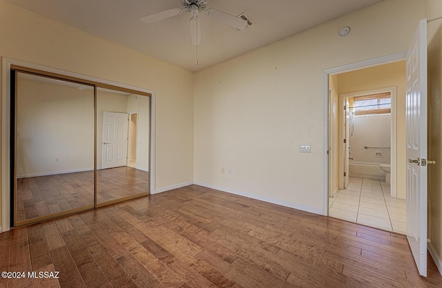 unfurnished bedroom with a closet, ceiling fan, and light wood-type flooring