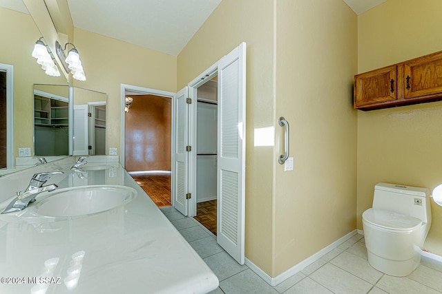 bathroom featuring tile patterned flooring, vanity, and toilet