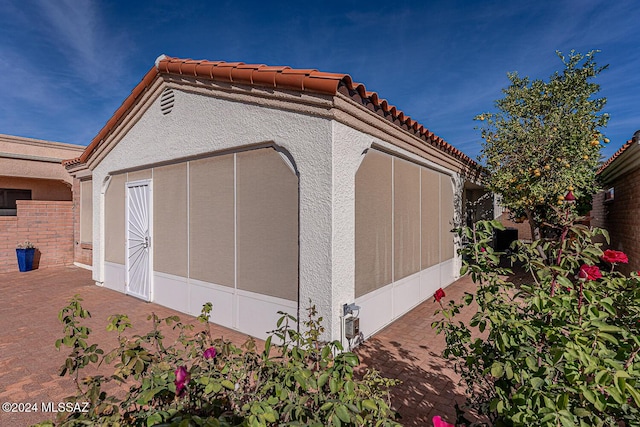 view of side of property with a sunroom