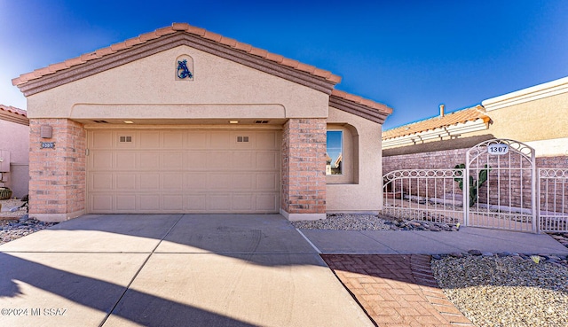 1307 W Mariquita St, Green Valley, AZ 85622 - view of front of property with stucco siding, driveway, and an attached garage