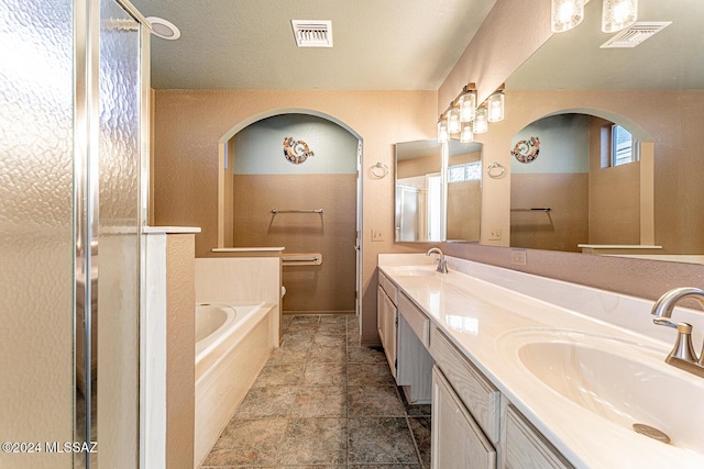 bathroom featuring vanity and separate shower and tub