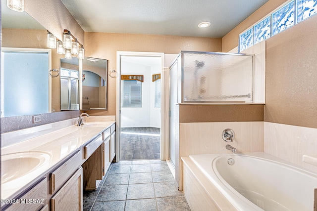 bathroom with vanity, tile patterned flooring, and separate shower and tub