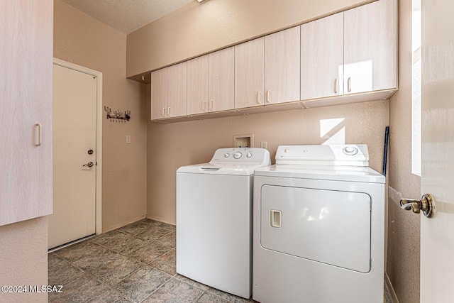 laundry area featuring cabinets, a textured ceiling, and independent washer and dryer