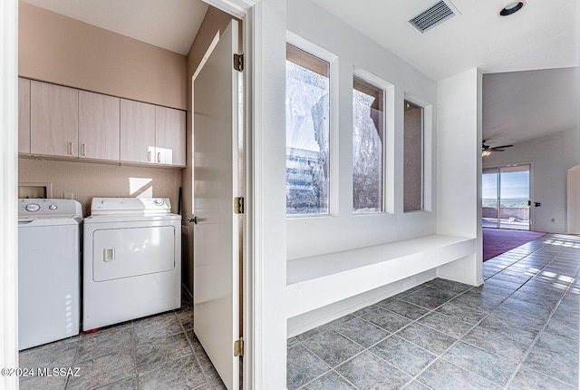 washroom with ceiling fan, cabinets, and washing machine and dryer