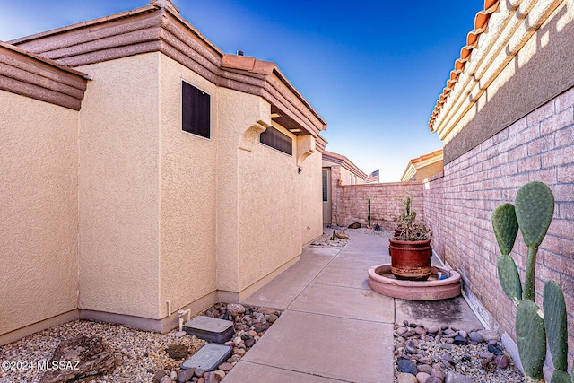 1307 W Mariquita St, Green Valley, AZ 85622 - view of side of property featuring stucco siding, a patio, and a fenced backyard